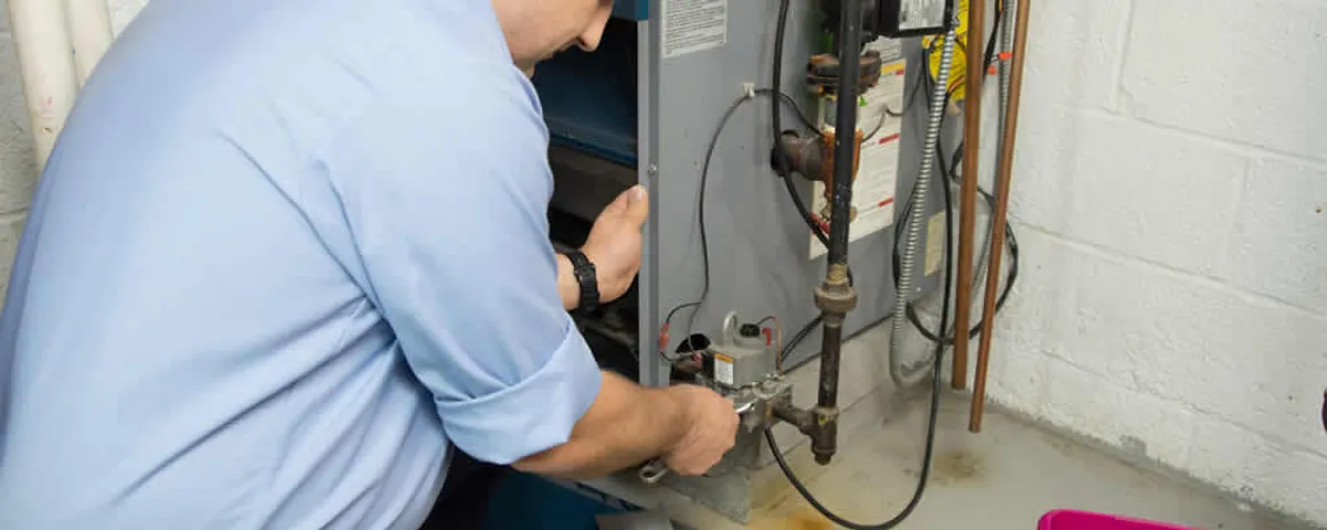 Furnace repair technician inspecting and servicing a home heating system in Allen, TX