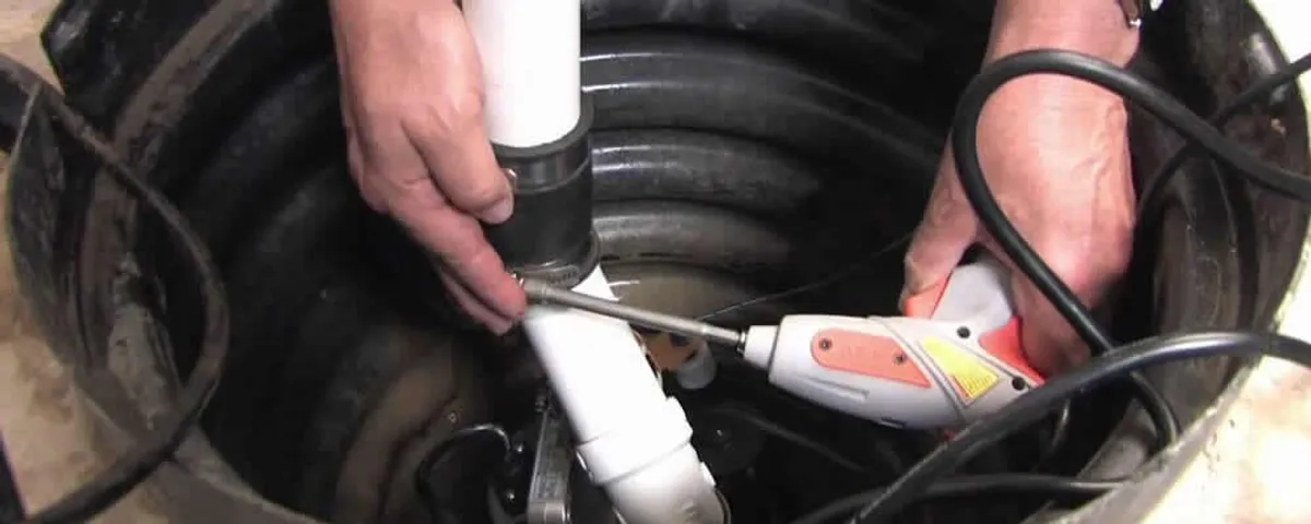 Sump pump installation technician connecting PVC discharge piping in Allen, TX